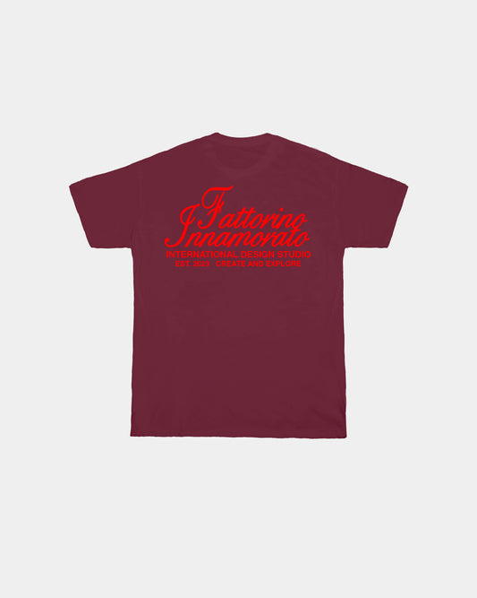 Burgundy red t-shirt with a graphic and text on the back against a white background. Fattorino Innamorato international burgundy red 