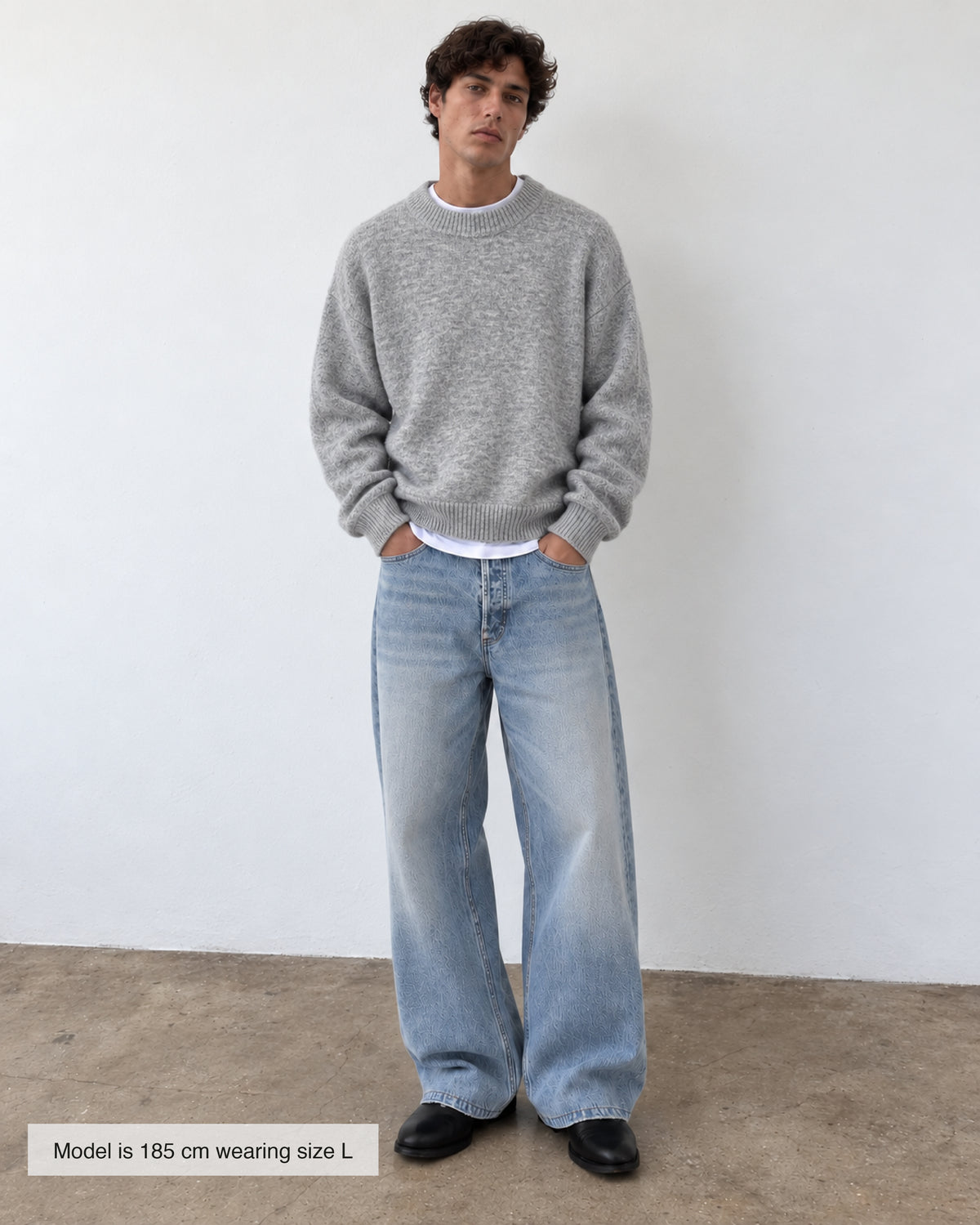 A light grey heathered knit crewneck sweater with ribbed cuffs and hem, displayed flat against a light gray background. Fattorino Innamorato grey knitwear sweaeter 