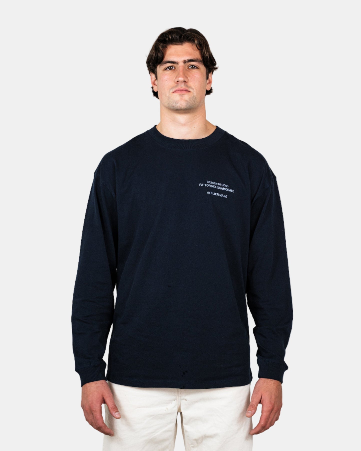 Man wearing a navy long-sleeve shirt with a logo on a white background. Fattorino Innamorato City Longsleeve

