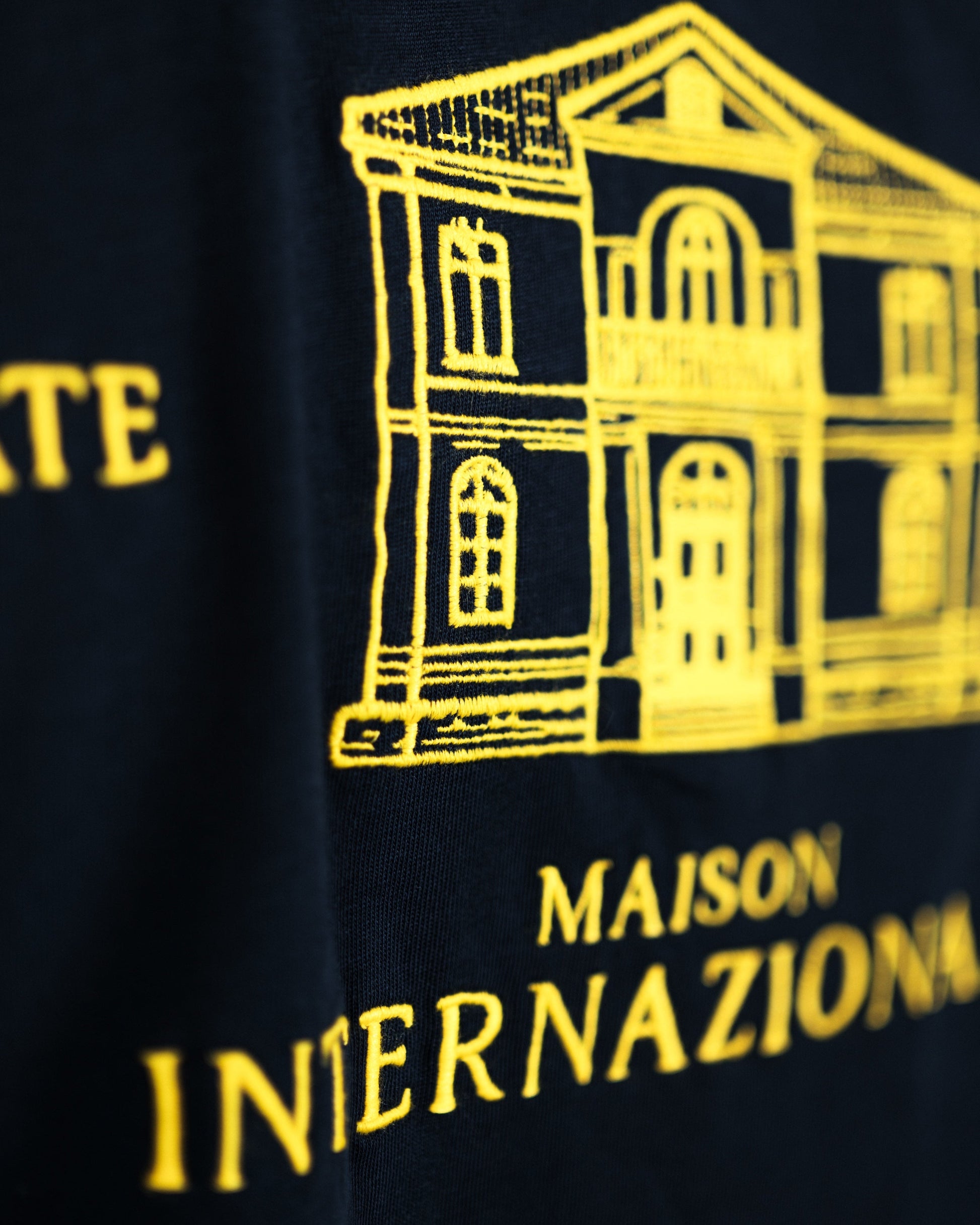 Navy blue fabric with yellow architectural illustration and text on a black background. Fattorino Innamorato maison longsleeve