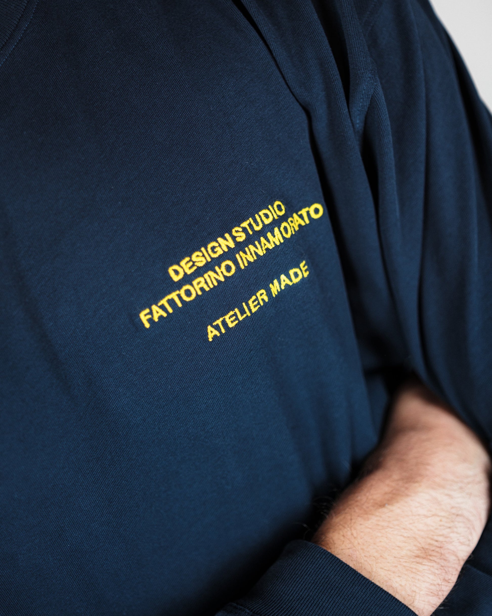 Navy blue sweatshirt with yellow text on the front. Fattorino Innamorato maison longsleeve