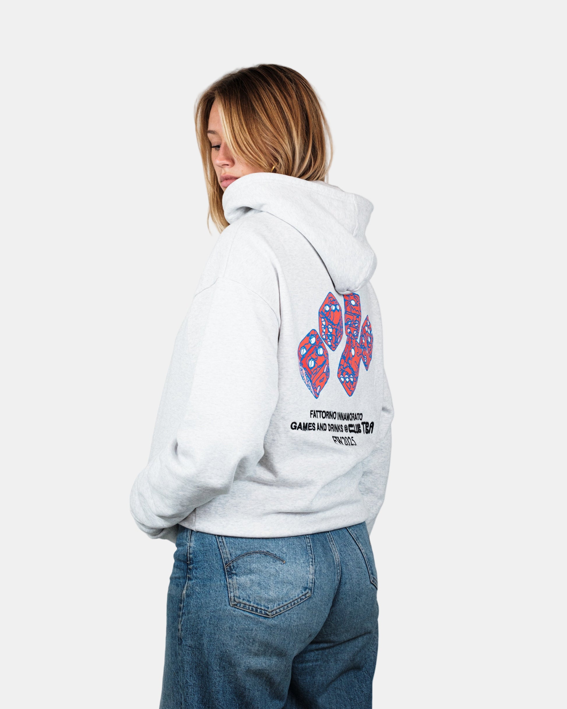 Person wearing a white hoodie with a colorful paw print design on the back, standing against a plain background. Fattorino Innamorato dice grey hoodie