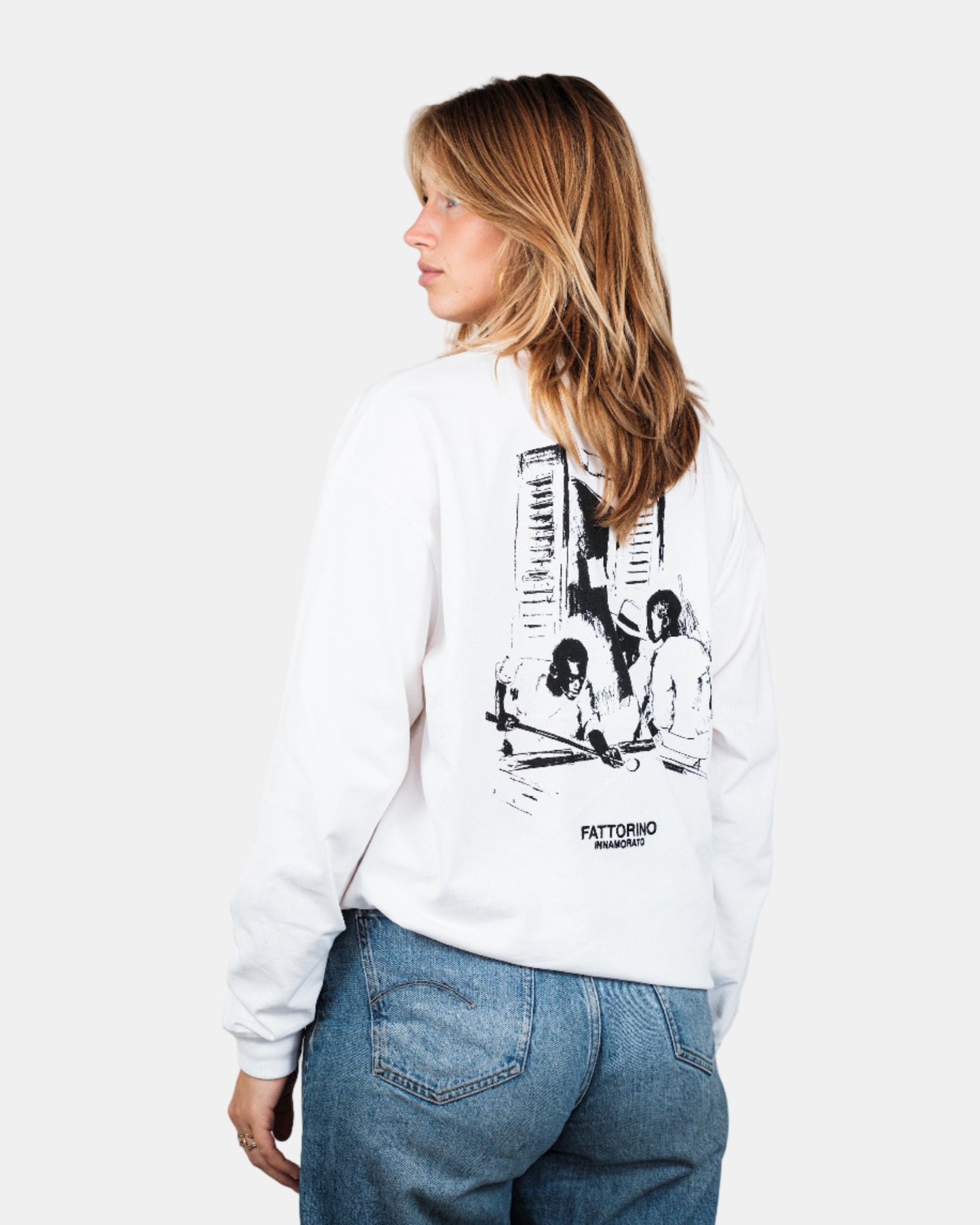Person wearing a white longsleeve tshirt with graphic design on a plain background. Fattorino Innamorato pool longsleeve