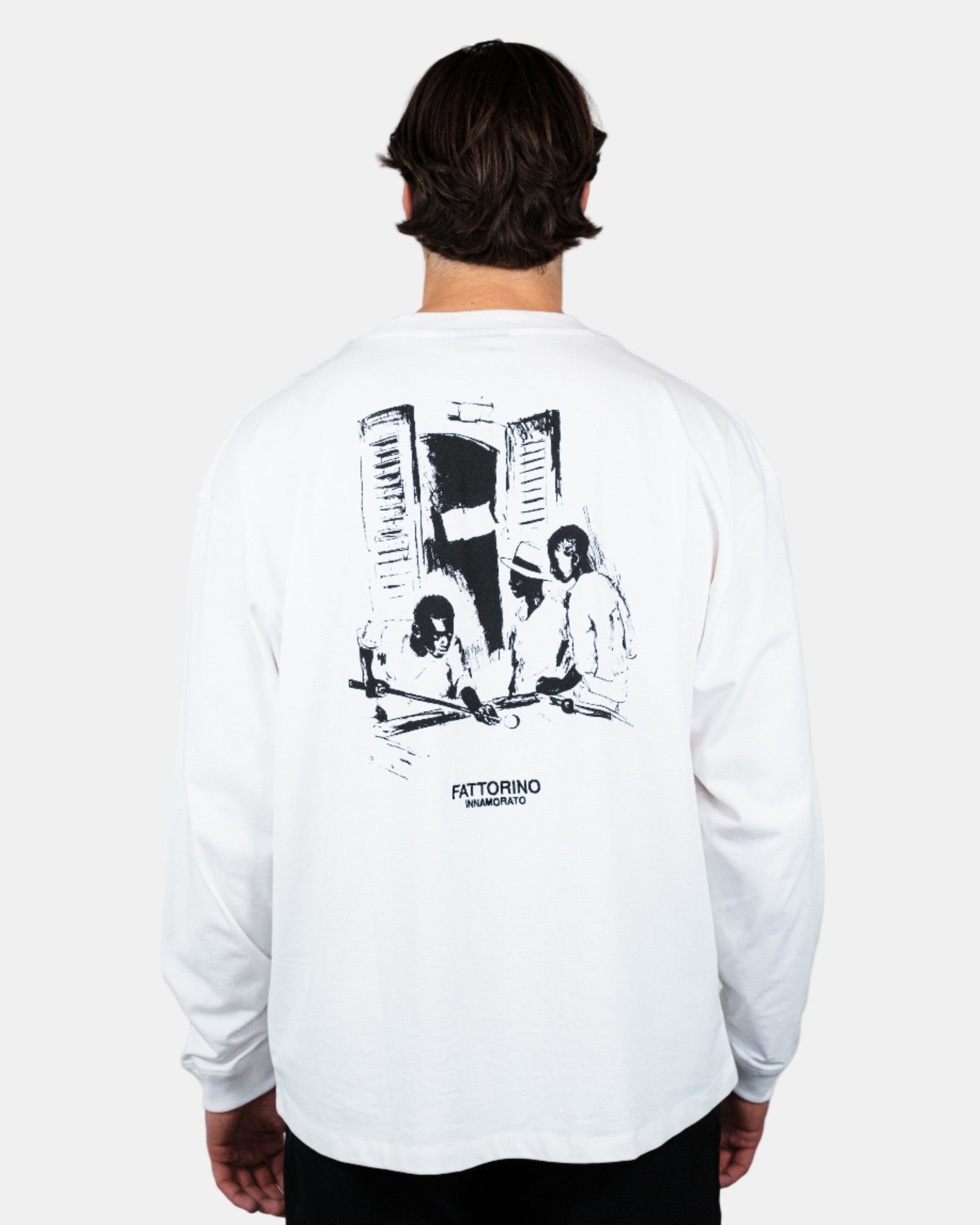 Person wearing a white long-sleeve shirt with black graphic design on the back, standing against a plain background. Fattorino Innamorato pool longsleeve