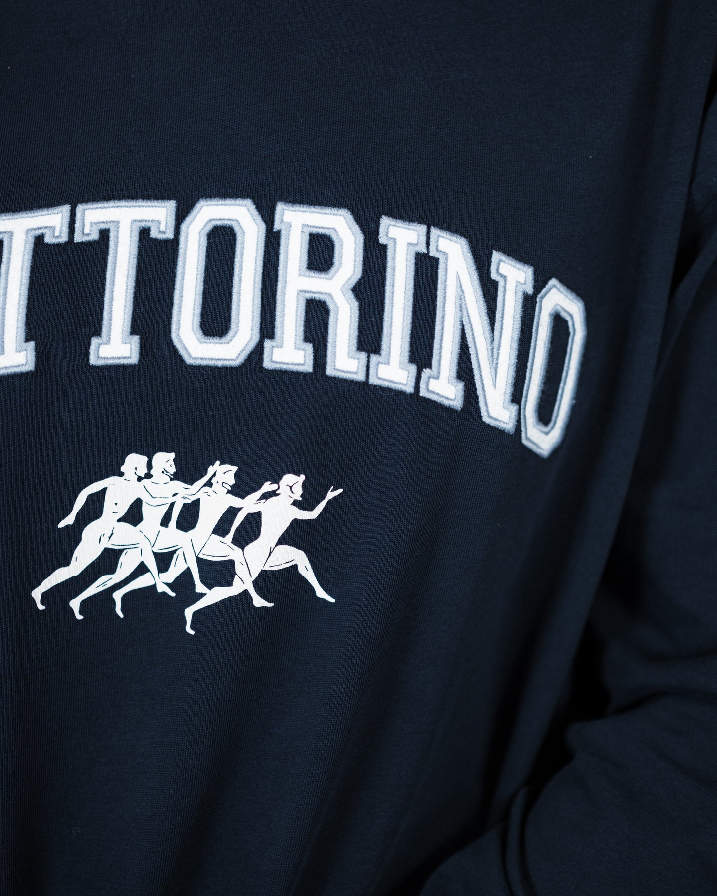 Navy blue sweatshirt with 'FATTORINO' text and white graphic on a dark background