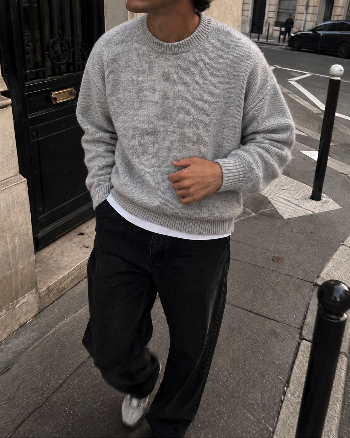 A light grey heathered knit crewneck sweater with ribbed cuffs and hem, displayed flat against a light gray background. Fattorino Innamorato grey knitwear sweaeter 