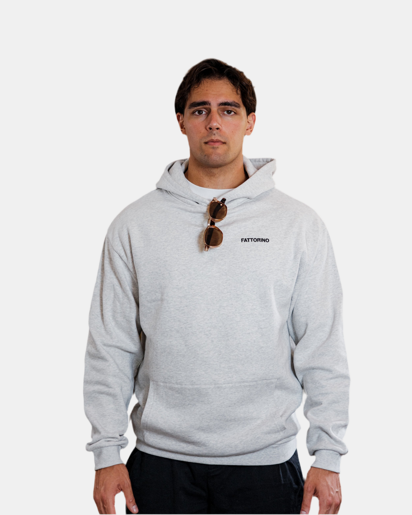 Person wearing a gray hoodie with colorful dice design and text on the back, on a white background. Fattorino Innamorato