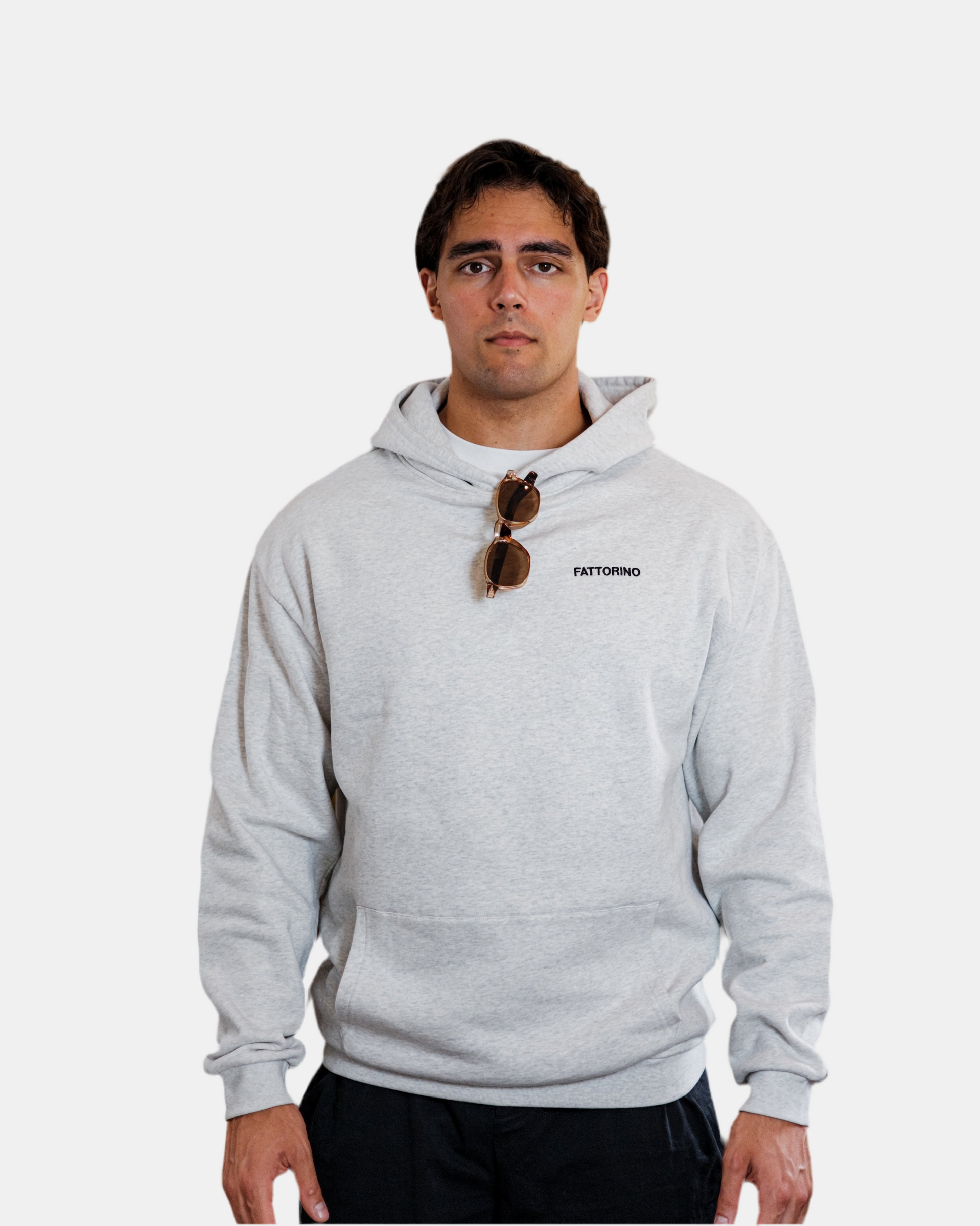 Person wearing a gray hoodie with colorful dice design and text on the back, on a white background. Fattorino Innamorato