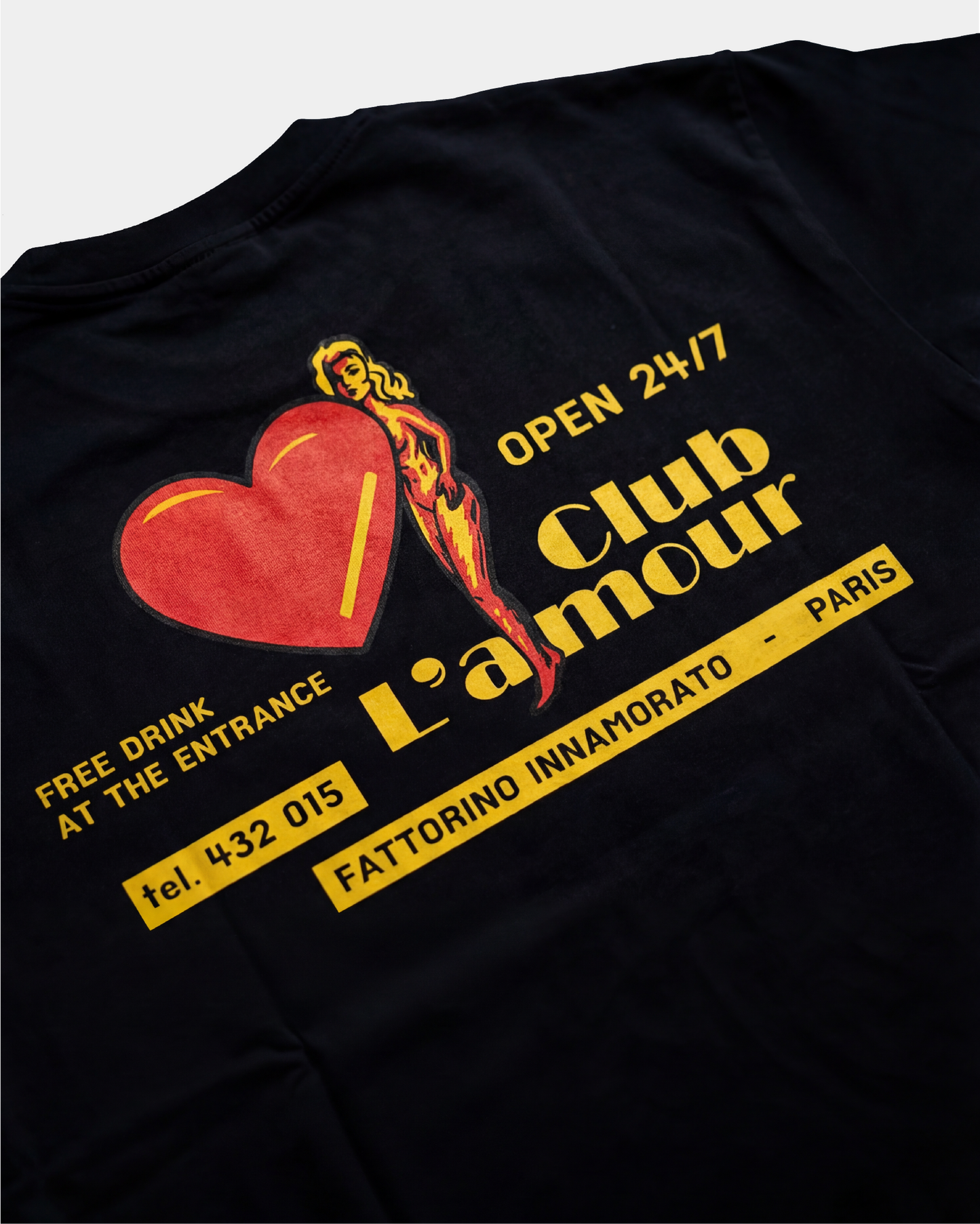 Black t-shirt with colorful graphic design on the back against a white background. Fattorino Innamorato club l'amour 