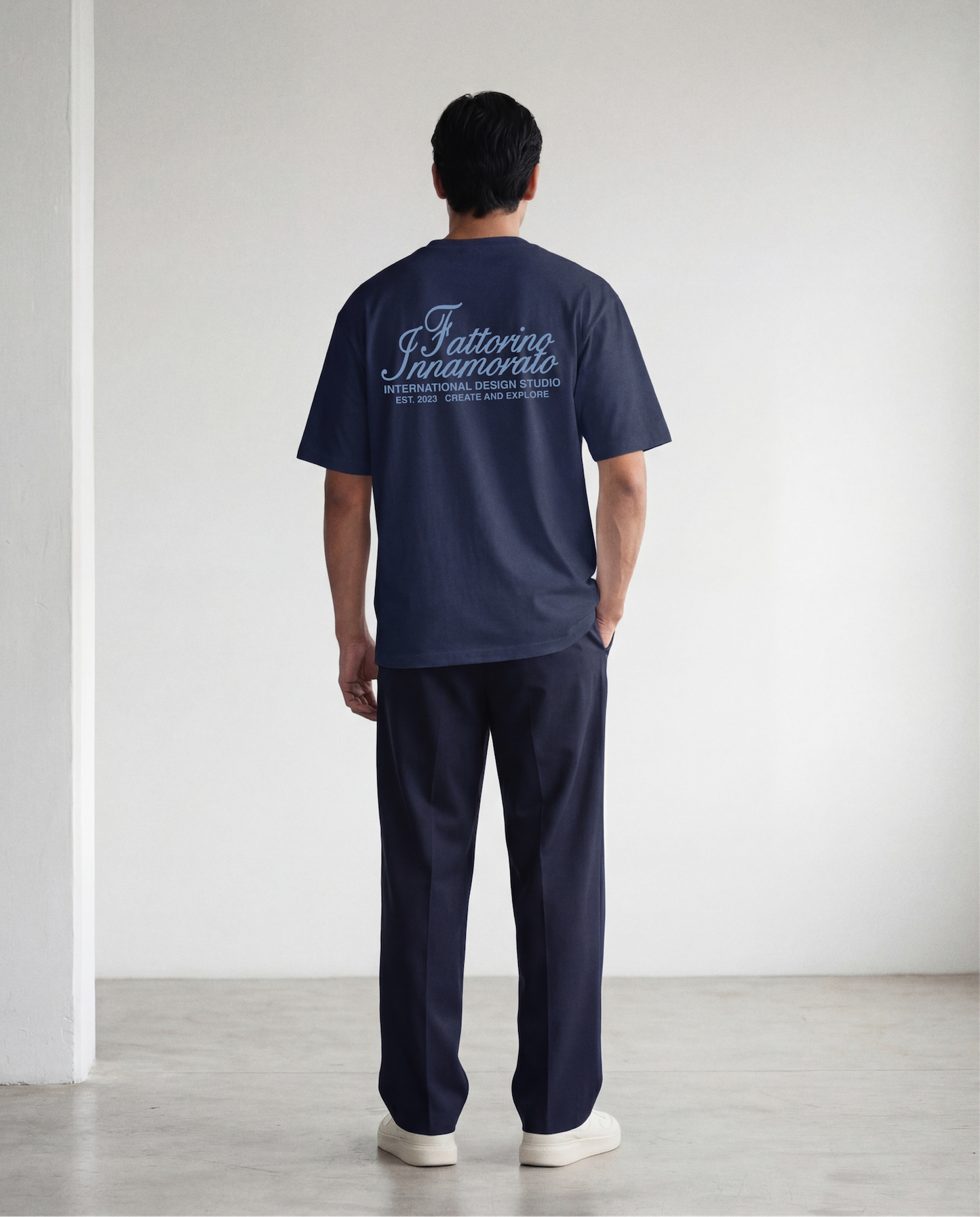 Navy blue t-shirt with blue text on a light gray background. Fattorino innamorato navy international